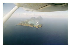 Lord Howe Island from a small plane. When traveling to this isolated island from Sydney, Qantas keeps a fully inflated lifeboat ready at all times in the middle of the passenger cabin. You have to step over it to get to your seat.